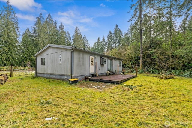 exterior space with crawl space, a lawn, and fence