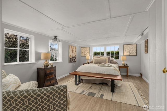 bedroom with multiple windows and light hardwood / wood-style flooring