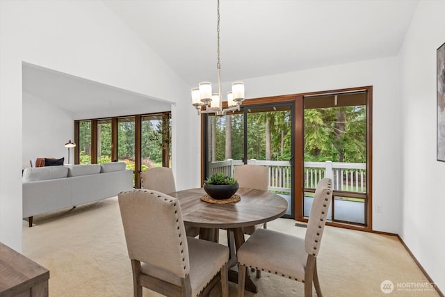 dining room featuring baseboards, light carpet, a chandelier, and vaulted ceiling