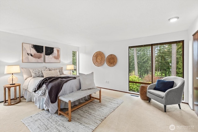 bedroom with access to exterior, baseboards, visible vents, and light carpet