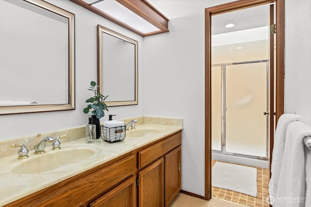 full bath featuring double vanity, a shower stall, and a sink