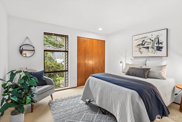 carpeted bedroom with recessed lighting and a closet