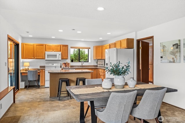 dining room featuring recessed lighting and baseboards