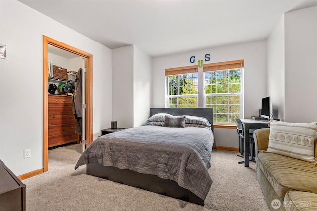 bedroom with light carpet and baseboards