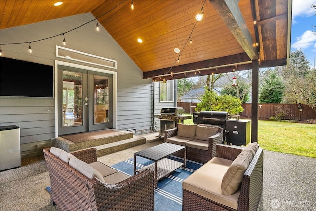 view of patio / terrace with french doors, fence, an outdoor living space, and grilling area