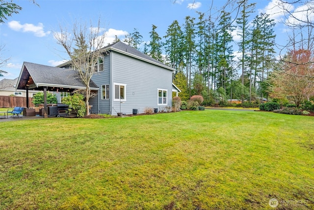 exterior space with a lawn and fence