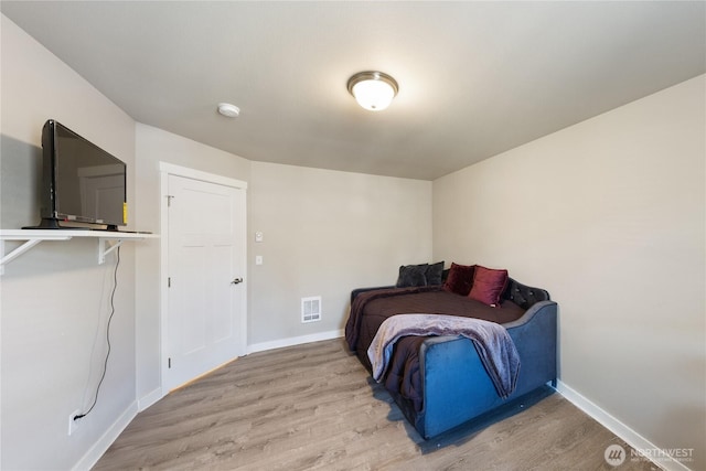 bedroom with wood-type flooring