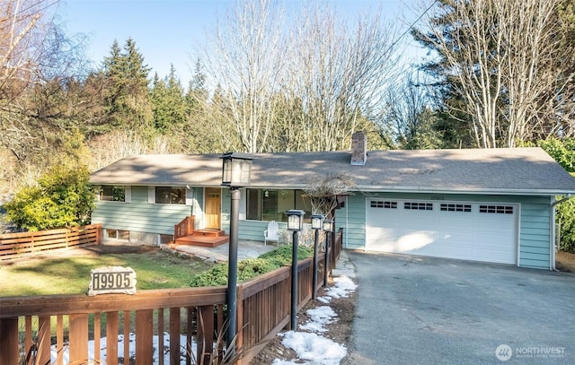 ranch-style house with a garage and a front yard