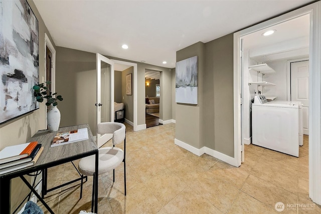 hallway featuring baseboards, washing machine and clothes dryer, and recessed lighting