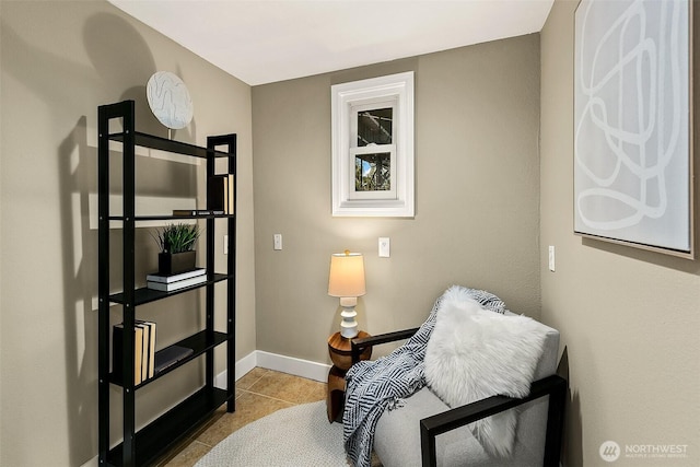 sitting room featuring light tile patterned floors and baseboards