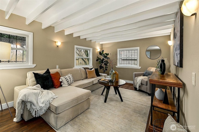 living room with wood finished floors, beam ceiling, and baseboards