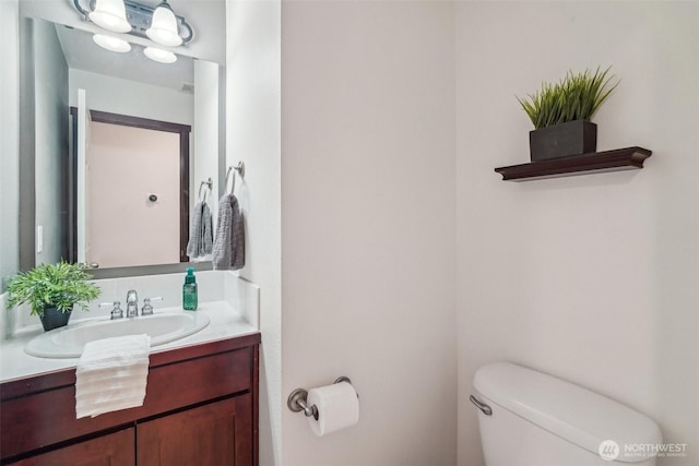 half bathroom featuring toilet and vanity