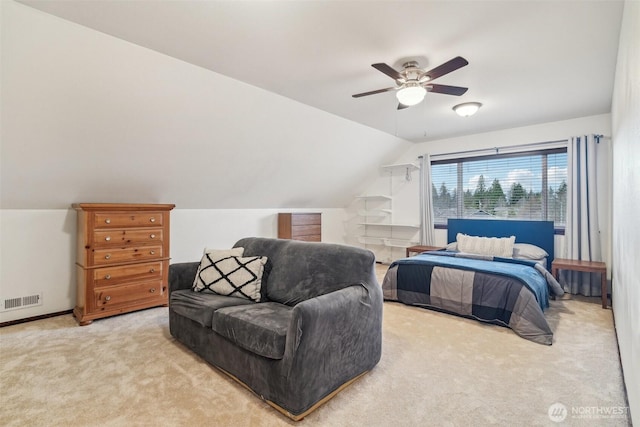 carpeted bedroom featuring visible vents, lofted ceiling, baseboards, and ceiling fan