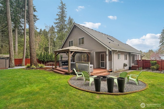 back of house featuring a fire pit, a gazebo, fence, and a wooden deck