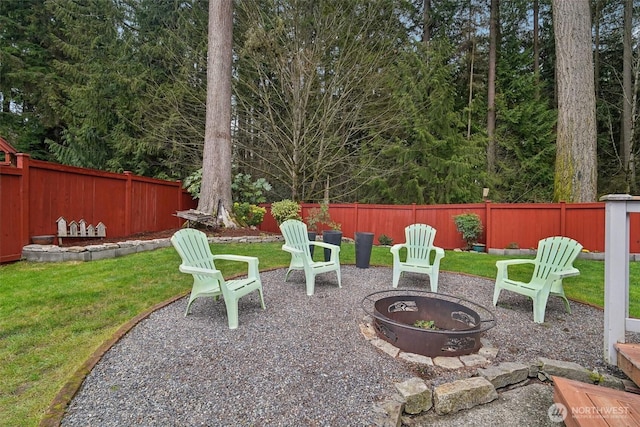 view of yard with a fire pit, a fenced backyard, and a patio area