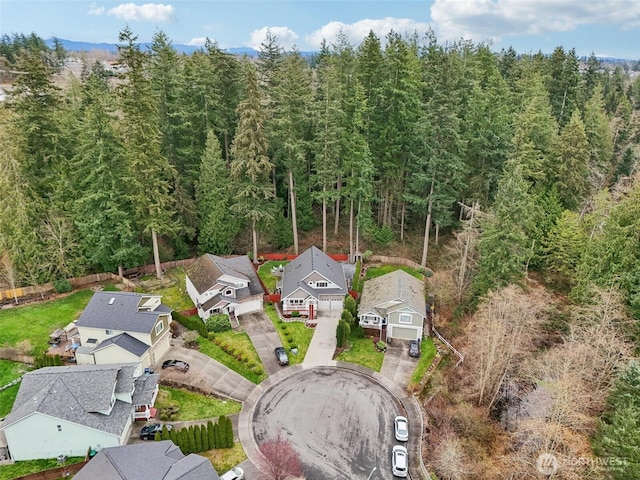 birds eye view of property featuring a forest view and a residential view