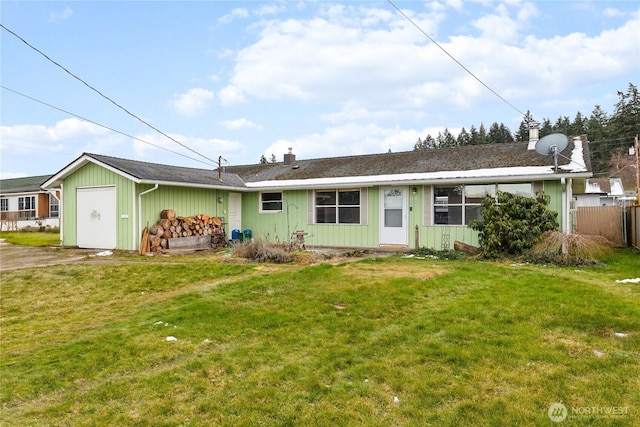 rear view of house featuring a yard