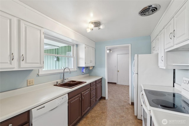 kitchen with dark brown cabinetry, sink, white cabinets, and white appliances