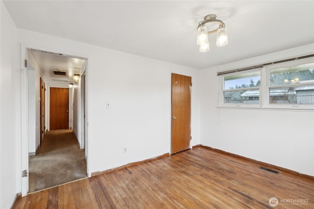 empty room with hardwood / wood-style flooring