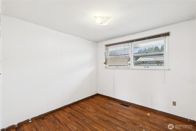 unfurnished room featuring dark hardwood / wood-style flooring