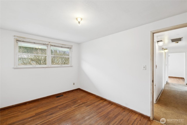 spare room with hardwood / wood-style flooring