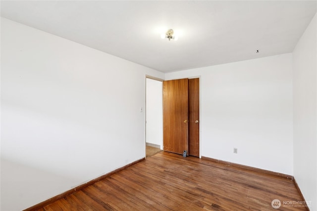 spare room featuring wood-type flooring