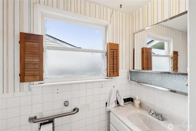 bathroom with vanity and tile walls