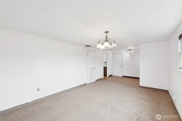 empty room featuring a notable chandelier