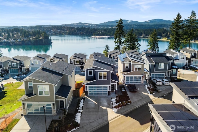 drone / aerial view with a water and mountain view