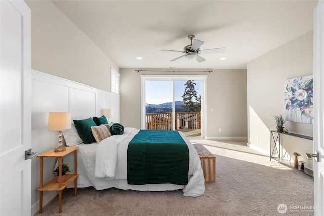 bedroom featuring ceiling fan, access to exterior, a mountain view, and carpet floors