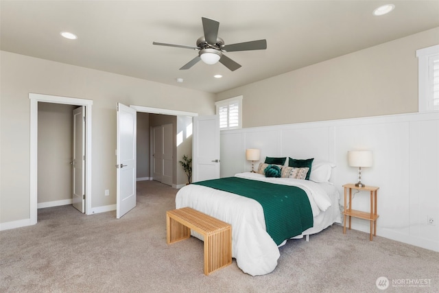 bedroom with ceiling fan and light carpet