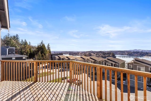 wooden terrace featuring a water view