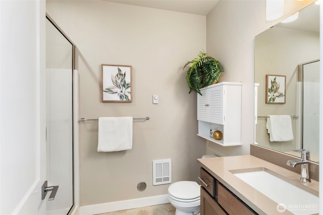 bathroom featuring vanity, toilet, and walk in shower