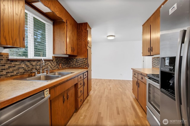 9901 S 232nd St, Kent, WA 98031 - kitchen with appliances with stainless steel finishes, light hardwood / wood-style floors, sink, and decorative backsplash