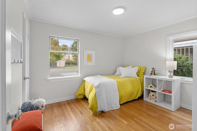 bedroom featuring crown molding and wood-type flooring