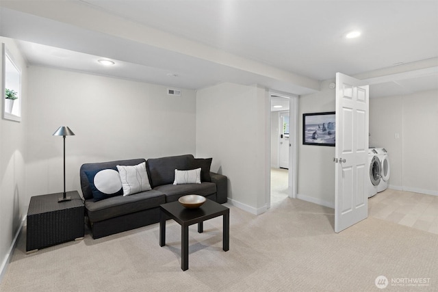 carpeted living room with washing machine and dryer