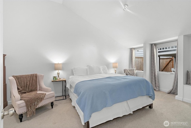 bedroom featuring vaulted ceiling and light carpet