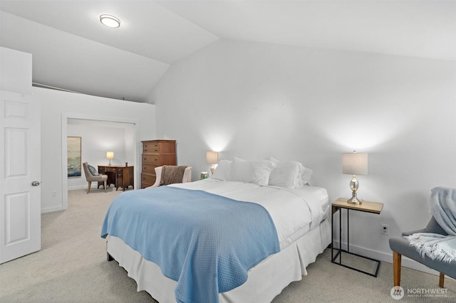 bedroom with lofted ceiling and light carpet