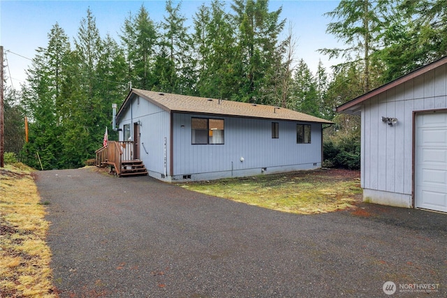 exterior space featuring crawl space and aphalt driveway