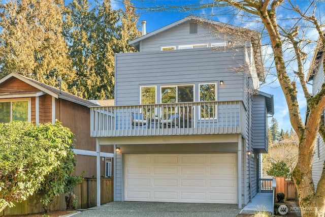 view of front property with a garage and a balcony