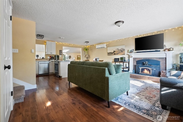 living room with dark wood-type flooring, a wall unit AC, a fireplace, and a textured ceiling