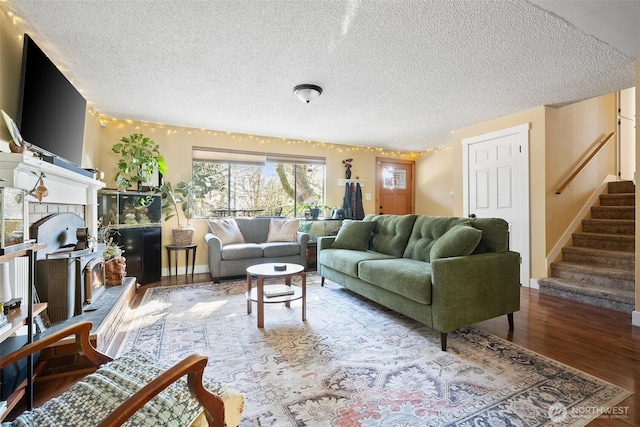 living room featuring hardwood / wood-style flooring and a textured ceiling