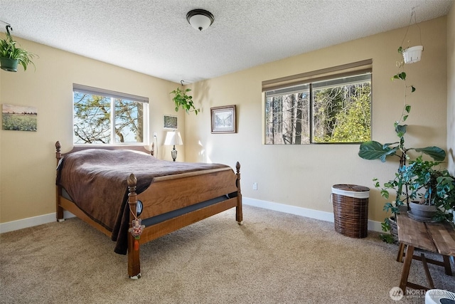 bedroom featuring light carpet and a textured ceiling