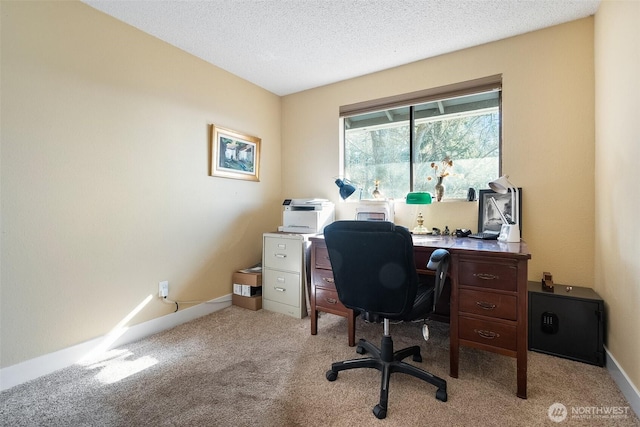 home office featuring light colored carpet and a textured ceiling