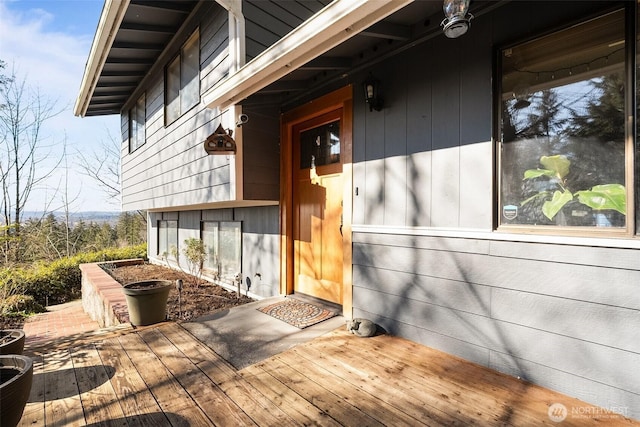 view of exterior entry with a wooden deck