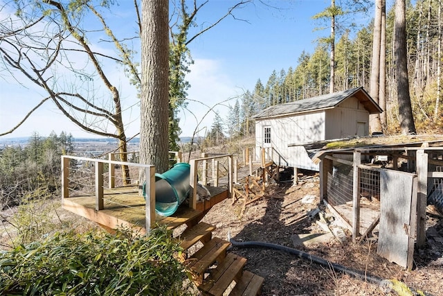 view of yard with a playground and an outbuilding