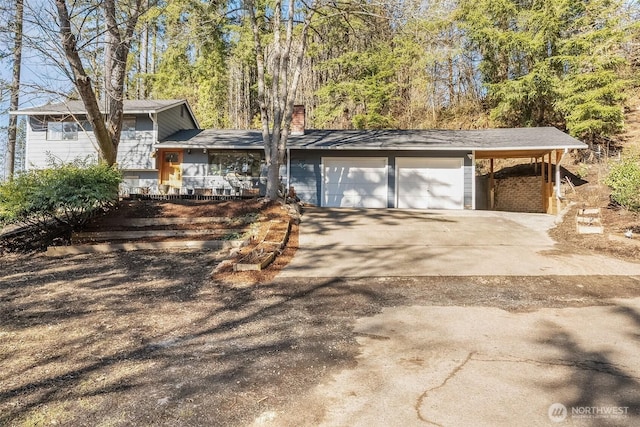 view of front of house with a carport and a garage