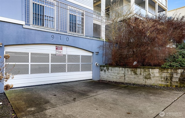 view of property featuring concrete driveway