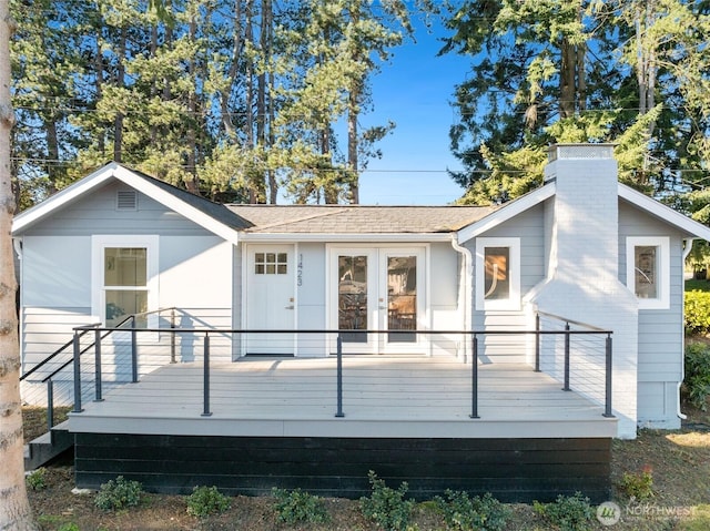 rear view of property with french doors and a wooden deck