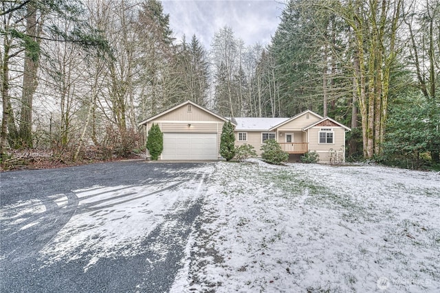 single story home featuring an attached garage and driveway